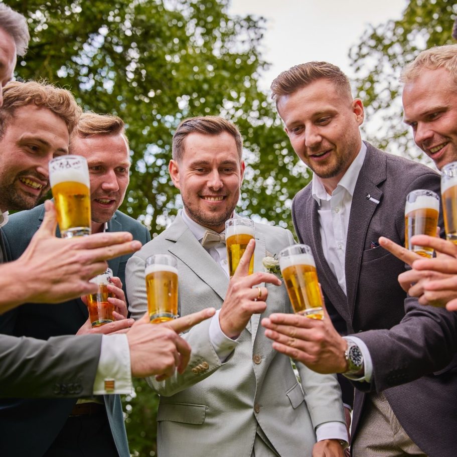 Freunde bei der Hochzeitsfeier Freunde des Brautpaares feiern die Sommerhochzeit auf dem Uphof in Bielefeld und stoßen gemeinsam mit Bier an
